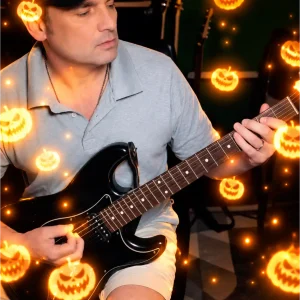 Back in Black on a Black Fat Strat Dan Joseph Teddington Guitarist Among Glowing Jack-o’-Lanterns.png